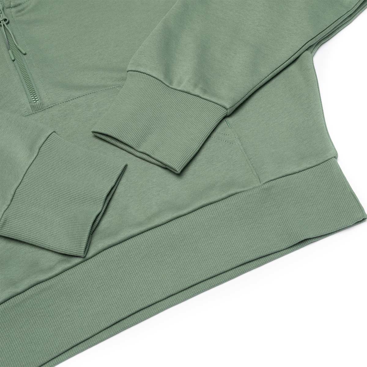 Bottom of a Green Hoodie with a half zipper and ribbed sleeve and bottom cuffs on a white background