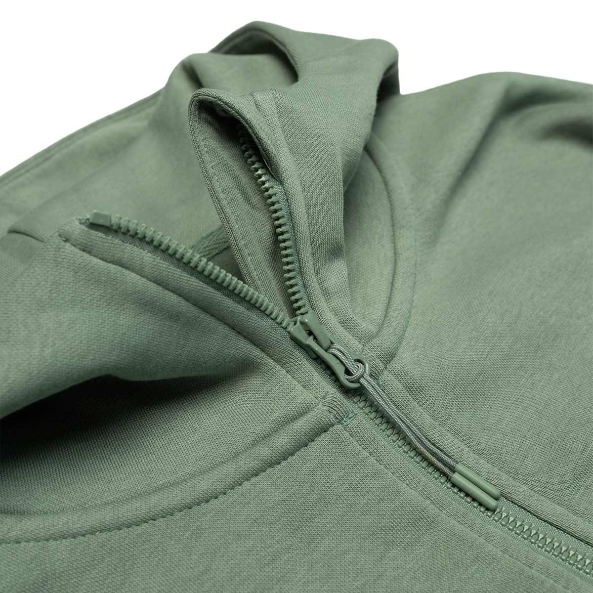 Close-up of a green hoodie with a zipper on a white background