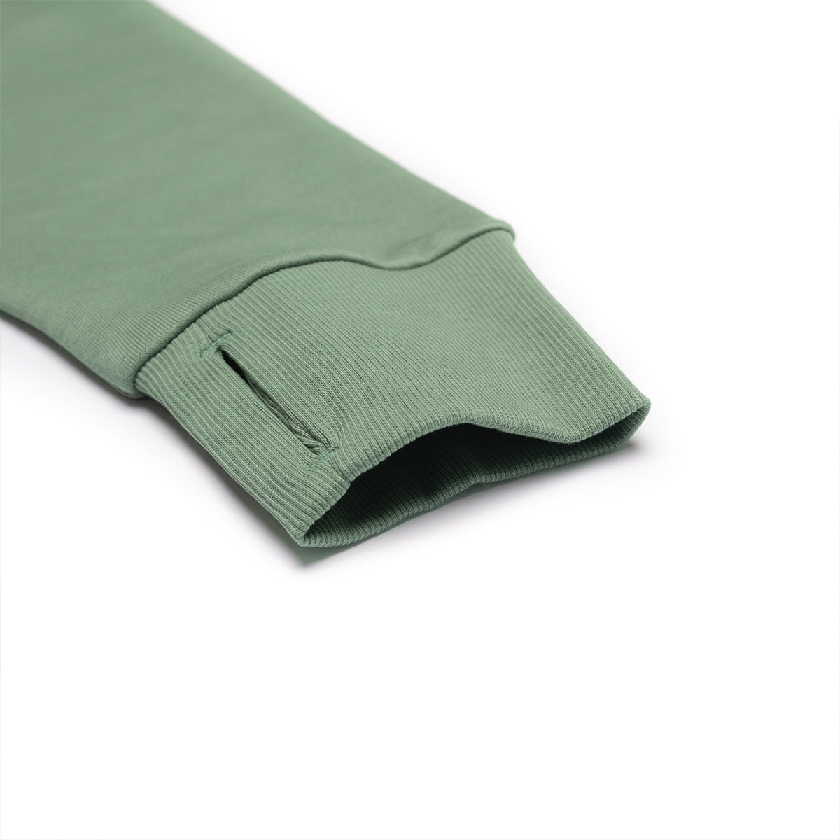 Close-up of a green sleeve with ribbed texture on a white background