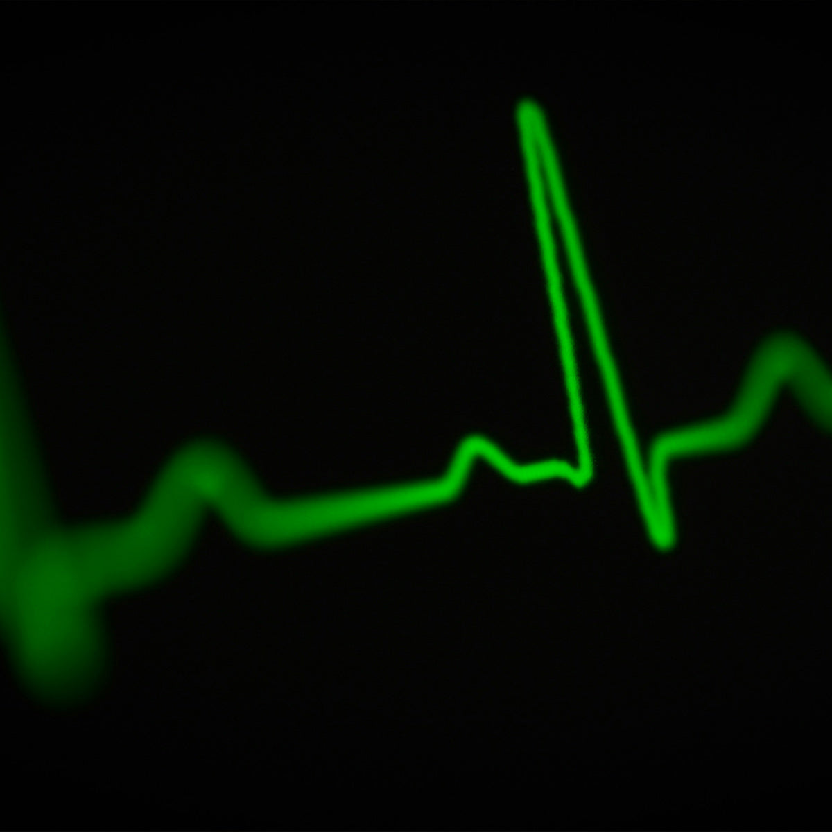 green pulse line on black background