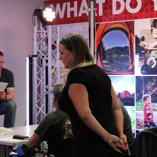 Woman walking around teaching event and checking progress of activity