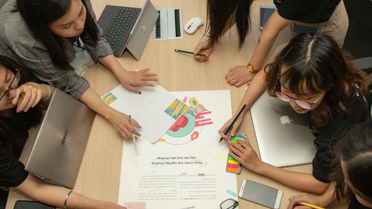 A group of people working together around a boardroom table.
