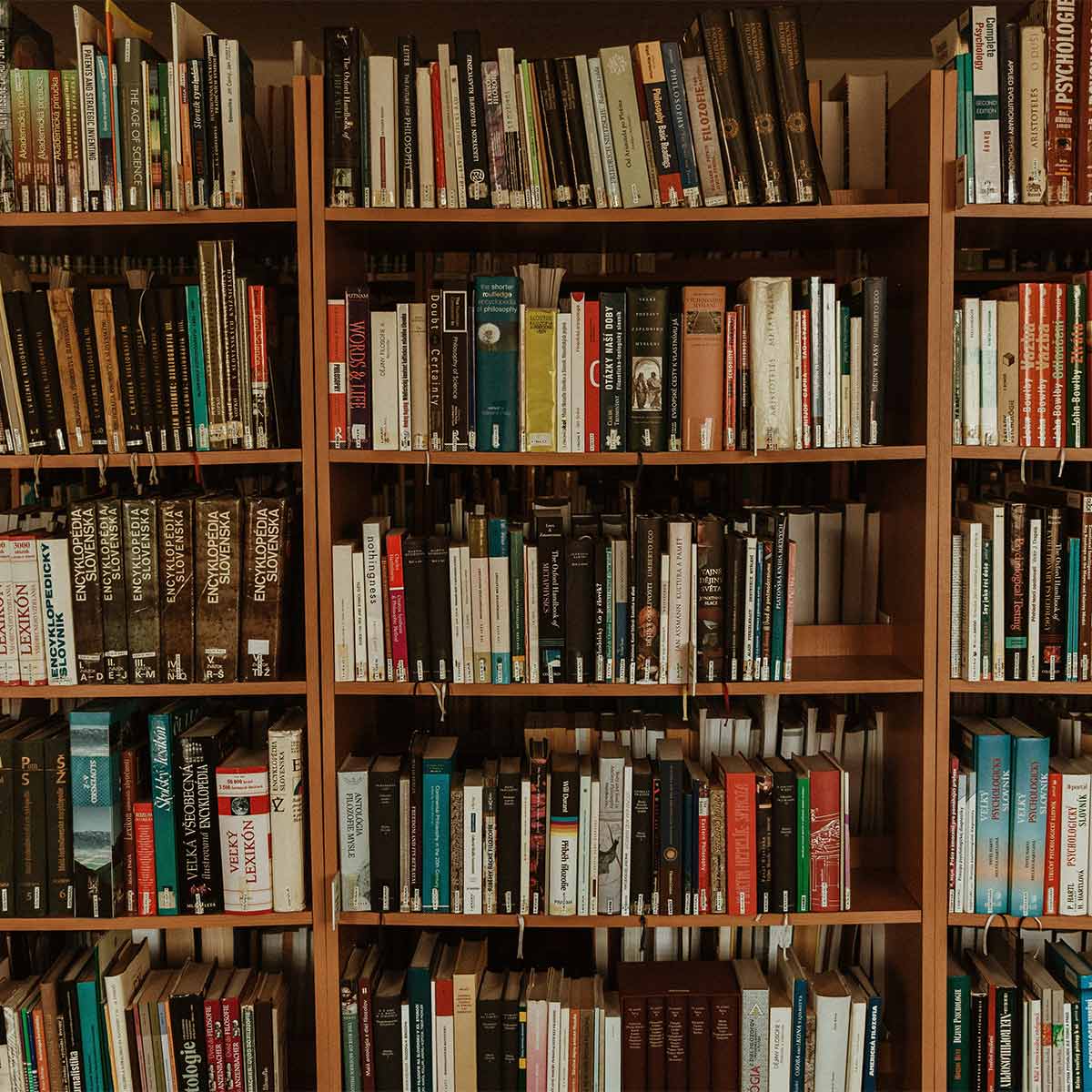 Bookshelf filled with a variety of books in a library setting