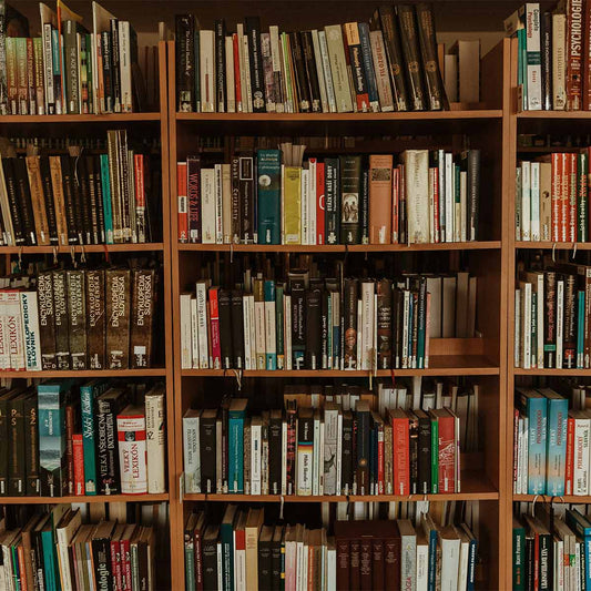Bookshelf filled with a variety of books in a library setting